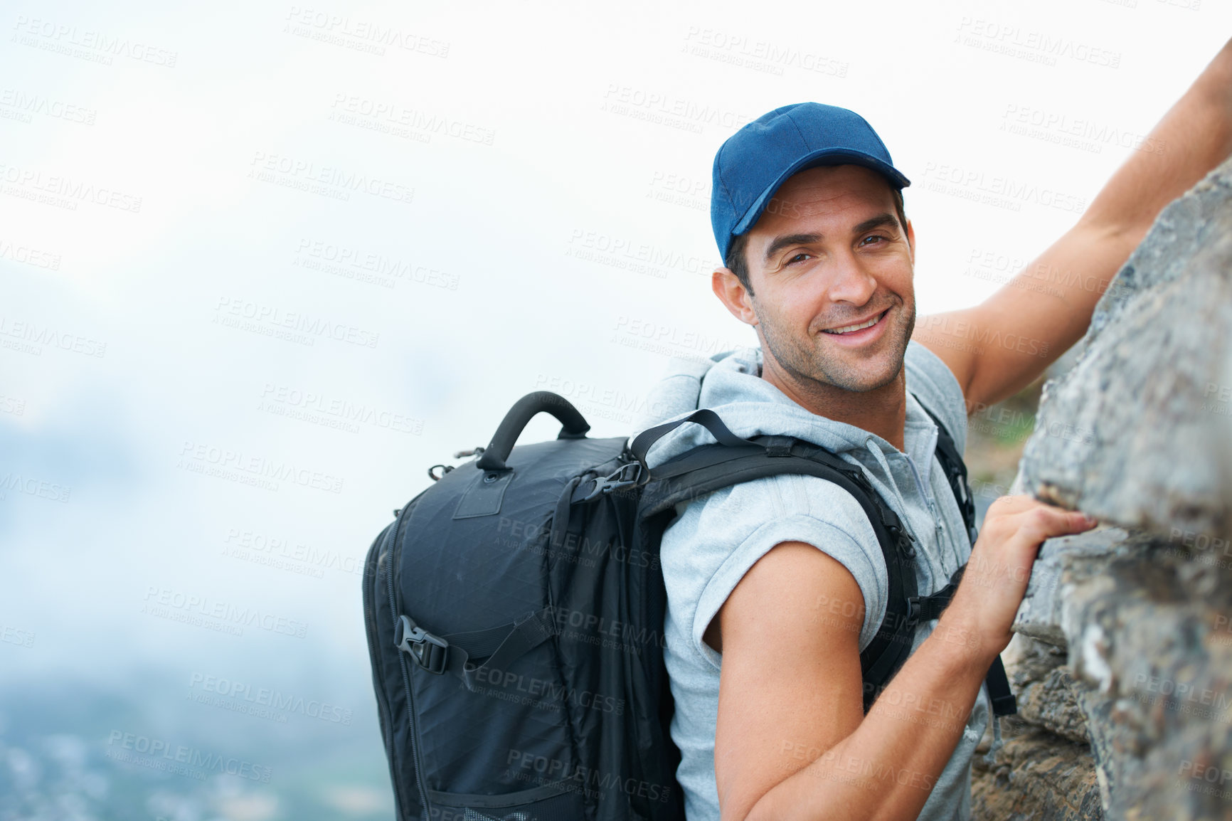 Buy stock photo Fitness, portrait and rock with man and climbing in nature for adventure, health and performance. Training, environment and explore with person on cliff of mountain terrain for backpacking and travel