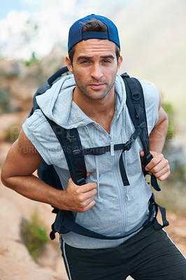 Buy stock photo Young hiker wearing a backpack looking at the camera