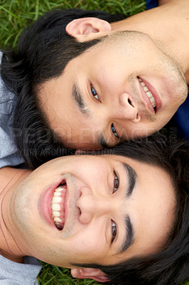 Buy stock photo Love, lgbt and relax with portrait of gay couple in grass from top view for freedom, bonding and happiness. Smile, relationship and happy with face of asian men in park for romance, nature and care