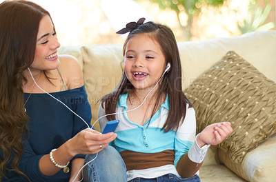 Buy stock photo Cute little girl listening to music with her mother