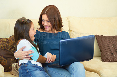 Buy stock photo Love, hug and mother with her child on a laptop while relaxing, talking and bonding on sofa. Happy, smile and young mom embracing girl kid while browsing on social media with computer in living room.