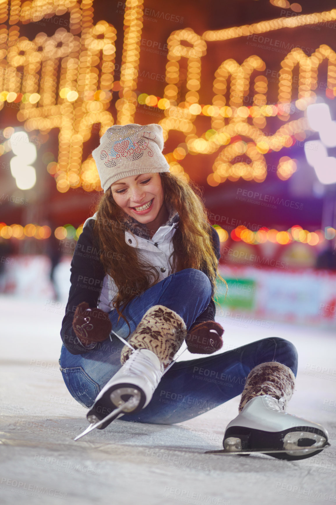 Buy stock photo Smile, ice skating and woman tie shoes on rink to start fitness, exercise and workout at night. Skater, happiness and female person tying skates for winter training, preparing and getting ready.