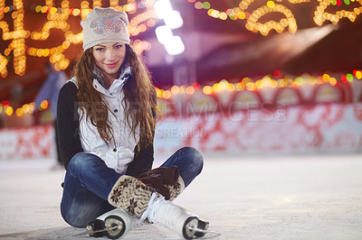 Buy stock photo Shot of a woman sitting on sitting on an ice rink