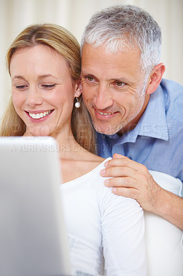 Buy stock photo A young married couple working on their laptop at home