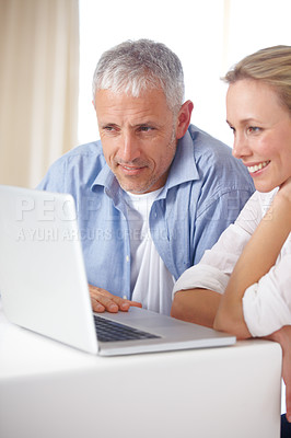 Buy stock photo Married couple, laptop and video call with smile, conversation and living room couch. Social media, technology and communication at home, husband and wife with connection, streaming and happy

