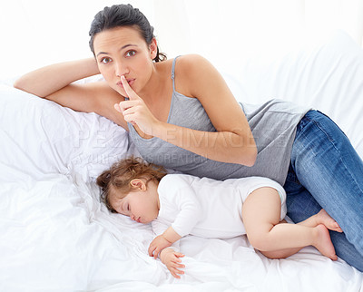 Buy stock photo Portrait of a mother telling you to be quiet so her daughter can sleep