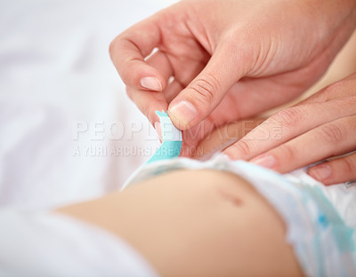 Buy stock photo Cropped image of a mother changing her baby's diaper
