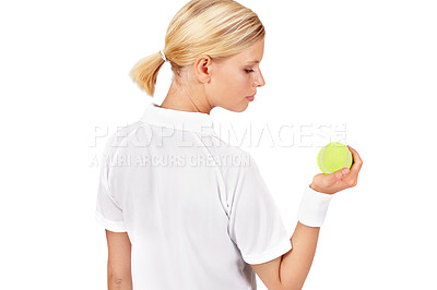Buy stock photo An attractive young woman holding and looking at a tennis ball