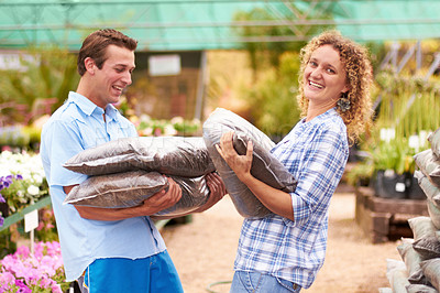 Buy stock photo A couple buying fertilizer in a local nursery