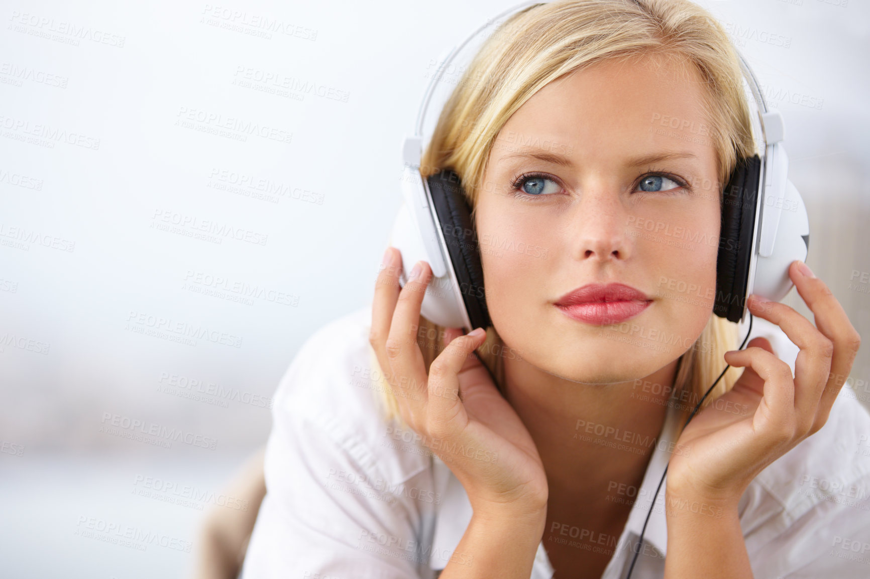 Buy stock photo Woman thinking, relax and listening to music with audio streaming service and mental health podcast at home on bed. Young student or person with ideas, vision and headphones for sound and inspiration