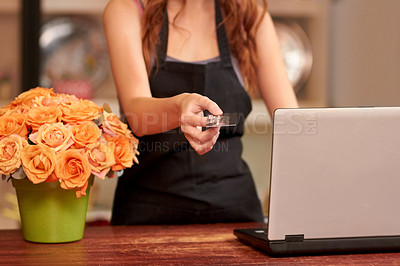 Buy stock photo Closeup of a florist's hands as she prepares a bouquet of flowers - cropped