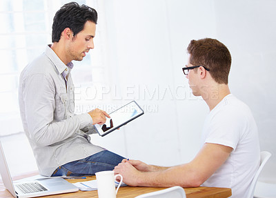 Buy stock photo Creative business people, tablet and discussion at desk in office for planning project, collaboration or online development. Design, teamwork or conversation with digital technology in startup agency