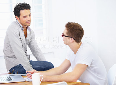Buy stock photo Creative, business men and discussion at desk in office for planning project, company collaboration and talking to employees. Designers, teamwork and conversation at table together in startup agency 