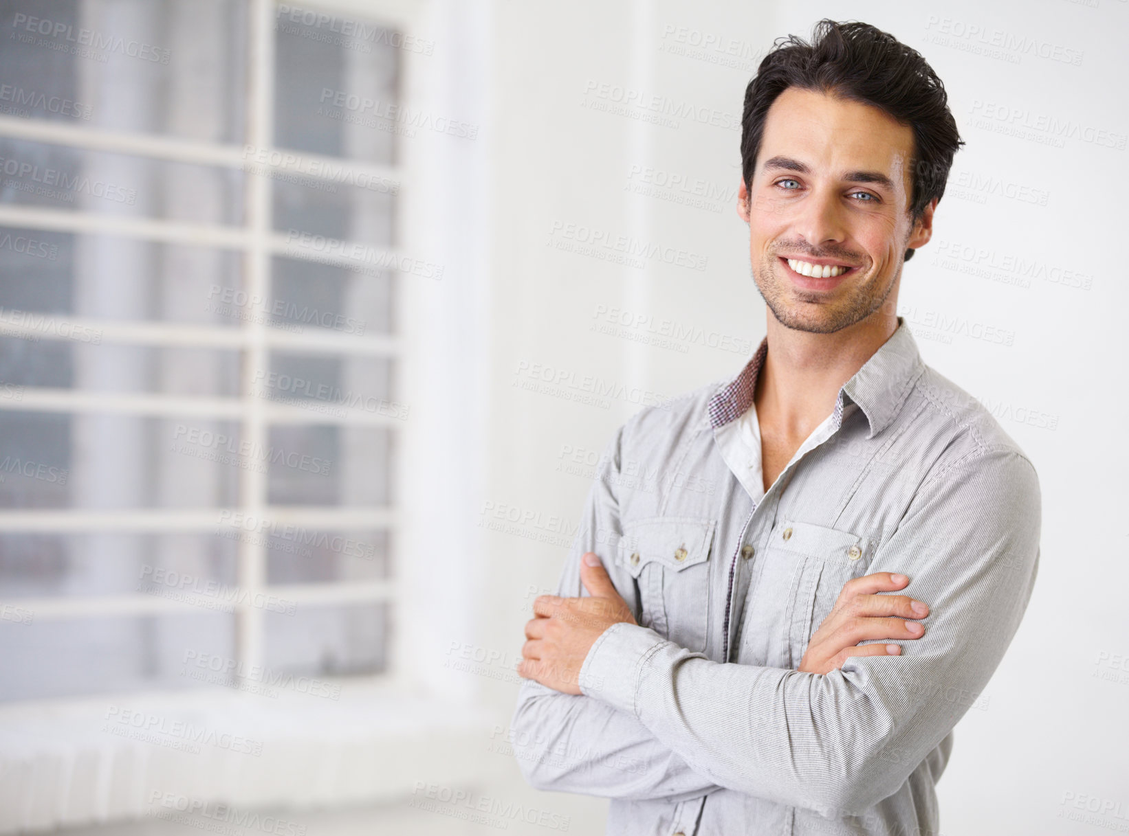 Buy stock photo Portrait of a smiling handsome man with his arms crossed