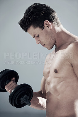 Buy stock photo Challenge, muscles and man with dumbbell weight in studio for bodybuilding workout, exercise or training. Sports, health and young male athlete from Canada with equipment isolated by gray background.