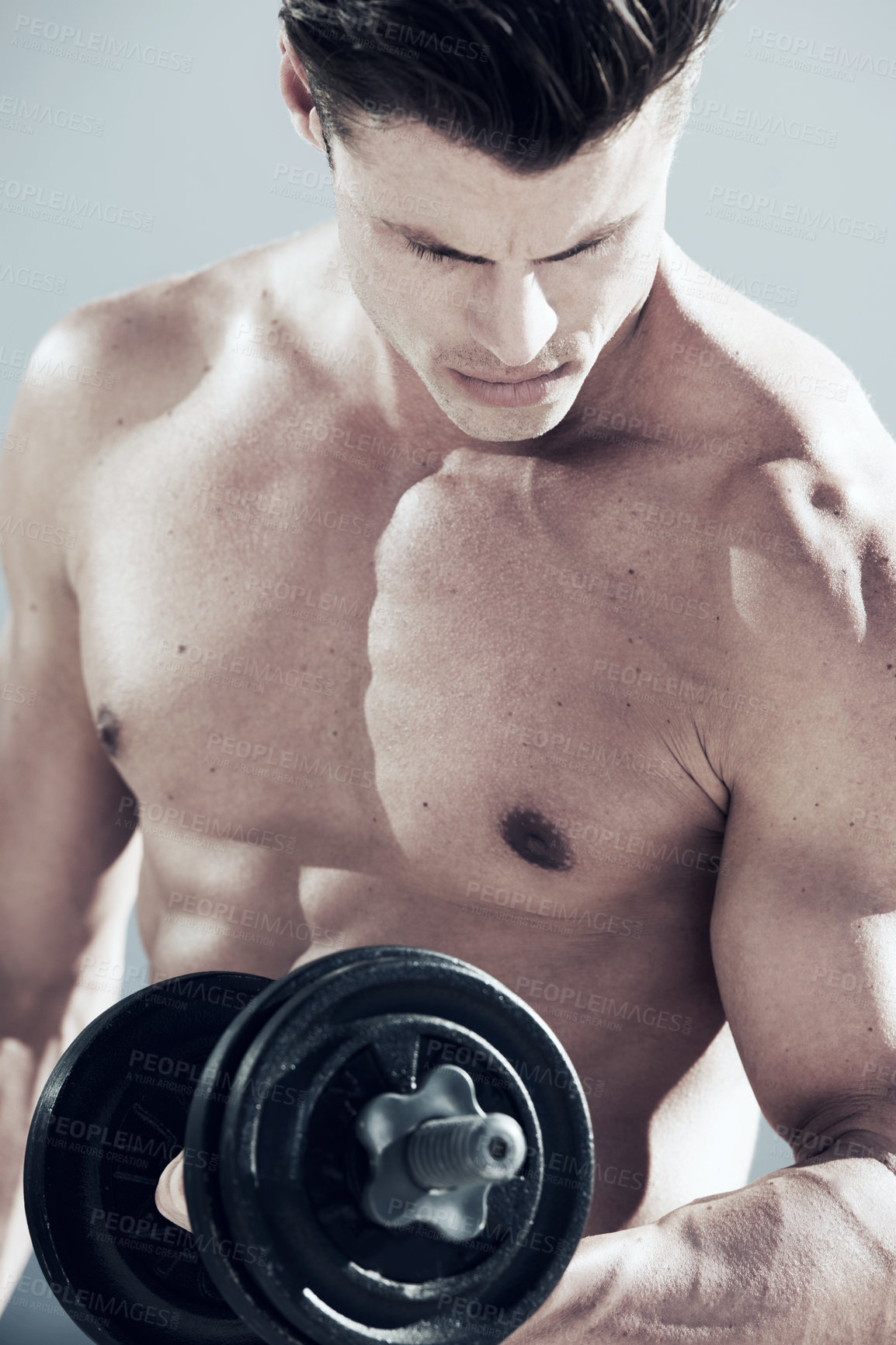 Buy stock photo A muscular male doings reps with a weight