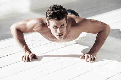 Buy stock photo A good looking male doing sit ups