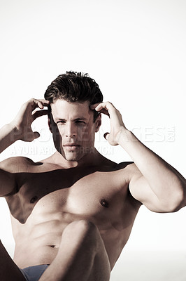 Buy stock photo A muscular male doing sit ups