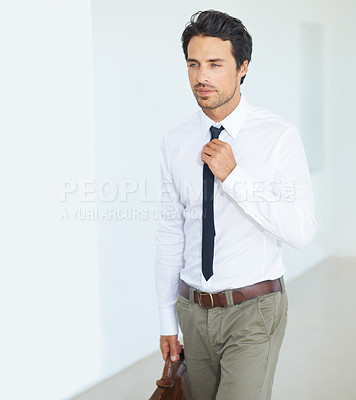 Buy stock photo Thinking, corporate and tie with a business man in a modern white collar office at work. Idea, getting ready or career and a handsome young male employee walking into in his workplace with ambition