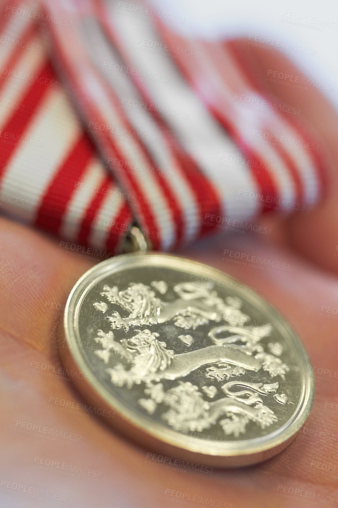 Buy stock photo Closeup, hands and war medal for hero, service and appreciation symbol or power gesture. Defence, award and person with gold military reward for honor, respect and Danish, army and airforce icon