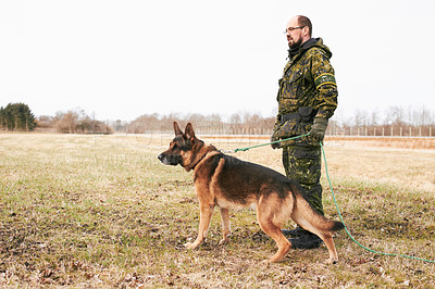 Buy stock photo Male officer, military uniform and german shepherd on leash or dog guarding territory and outdoors. Soldier, pet with rope and in the field for army training or drills or man official in gear outside