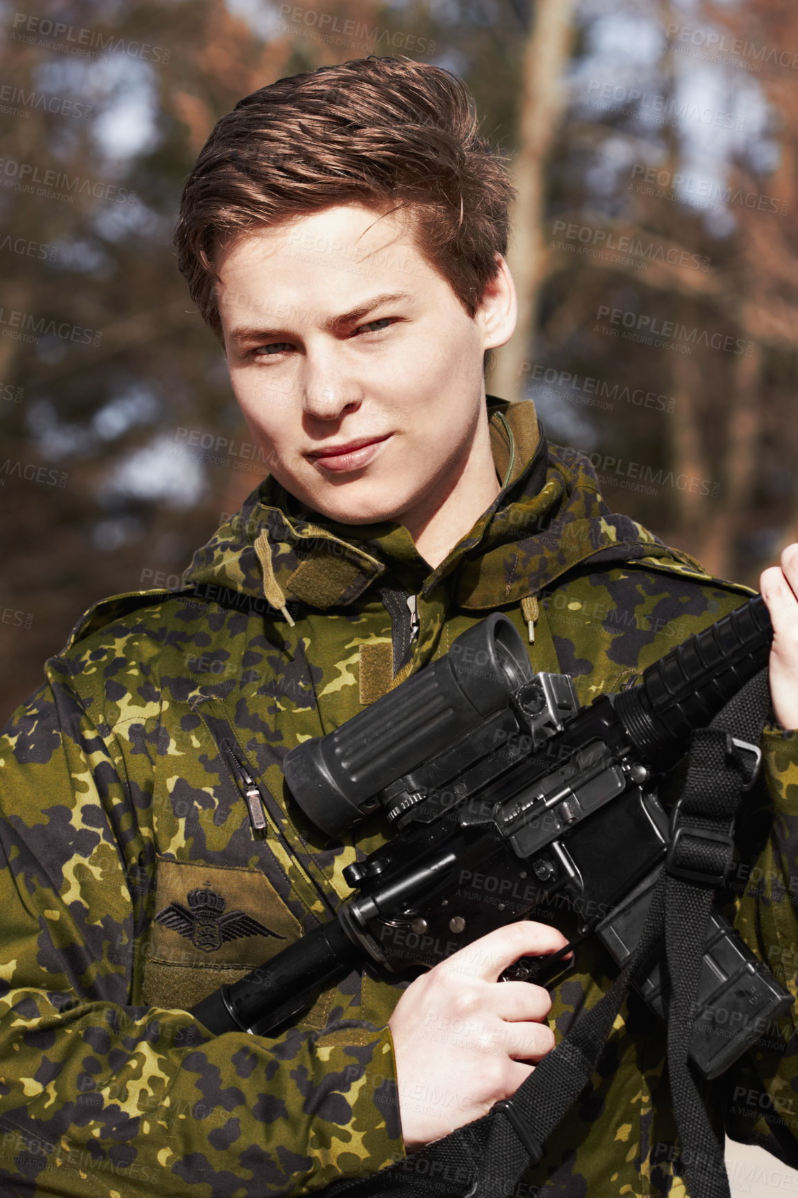 Buy stock photo A young soldier standing with a rifle