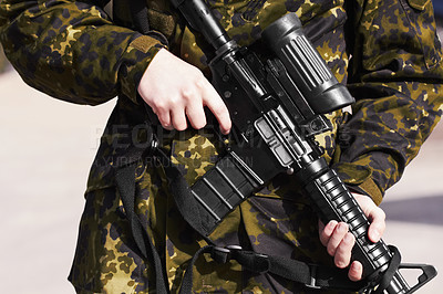 Buy stock photo Cropped image of a soldier holding a gun