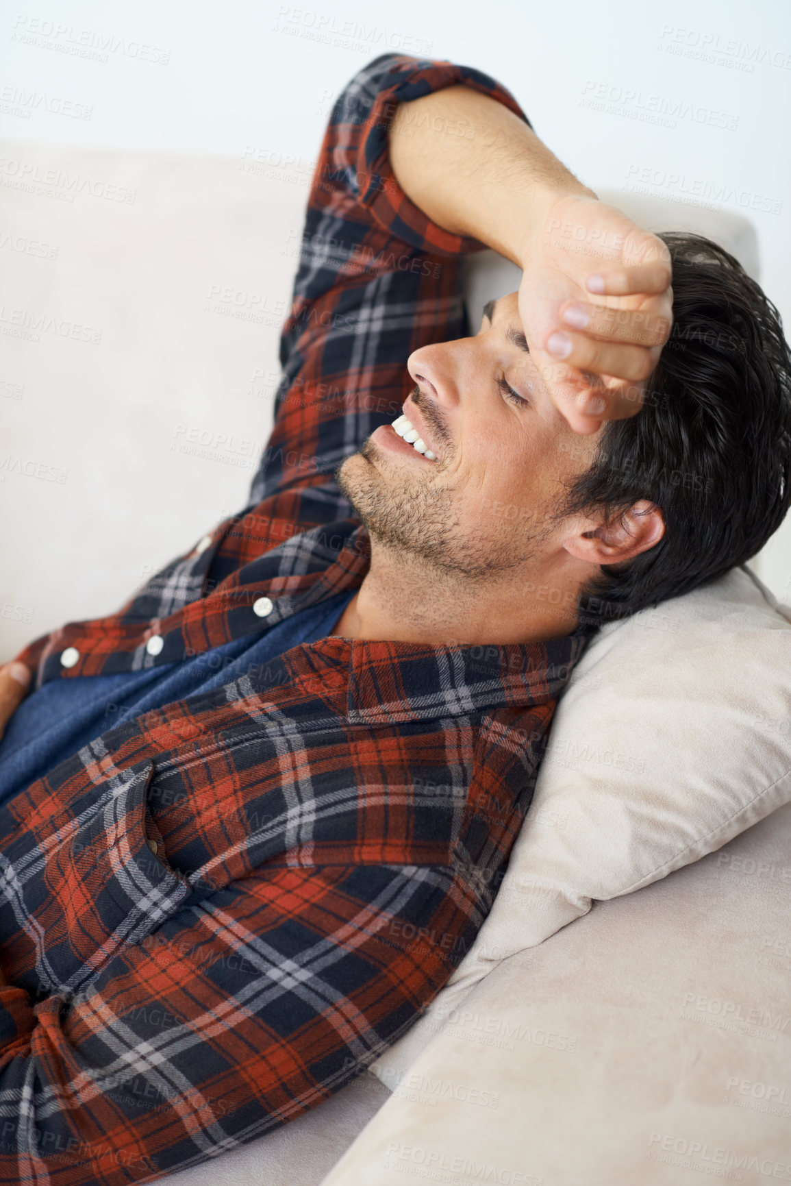 Buy stock photo Happy, relax and man on sofa in home for afternoon nap, resting and sleeping in living room. Asleep, eyes closed and tired person on couch lying for fatigue, comfortable and wellness in apartment