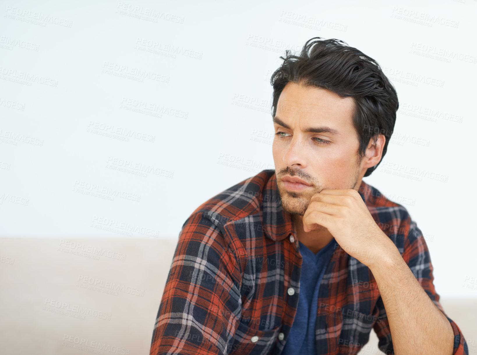 Buy stock photo Man, thinking and serious on sofa for question, idea and contemplating in living room of apartment or home. Person, face and mental health or thoughtful on couch in lounge for anxiety on weekend