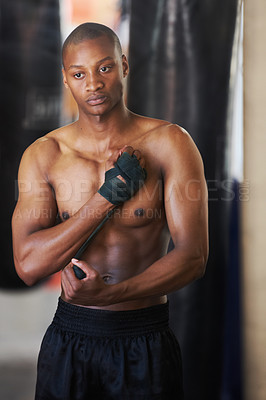 Buy stock photo Boxing, gym and black man wrapping hands with fitness, power and training challenge. Strong body, muscle workout and boxer in gym, athlete with confidence and getting ready for fighting competition.