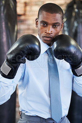 Buy stock photo Man, portrait and boxing gloves in suit confident for manager job, ready for business or corporate competition. Black person, face and fighter gear for office achievement, career promotion at work