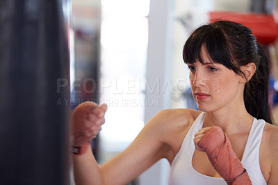 Buy stock photo Boxing, gloves and woman with bag, training and fitness for power, wellness and workout challenge. Strong body, muscle and girl boxer in gym, athlete with confidence and pride for competition fight