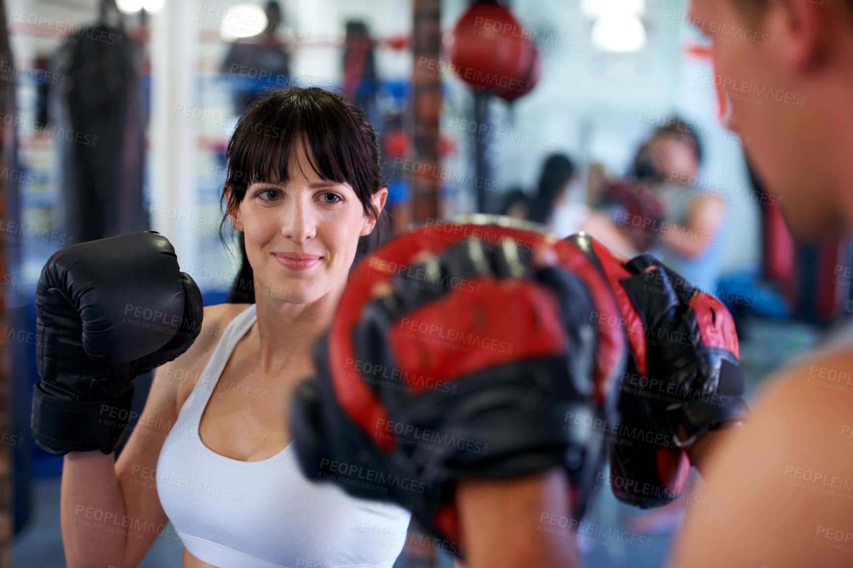 Buy stock photo A female boxer sparring with her practice partner