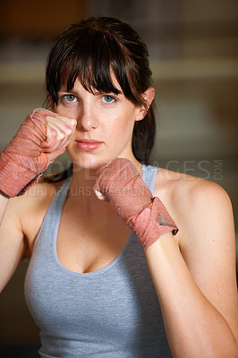 Buy stock photo Boxing, hands and portrait of woman with fitness, power and fearless training challenge in gym. Strong body, muscle and face of boxer, athlete or girl with fist up for confidence in competition fight