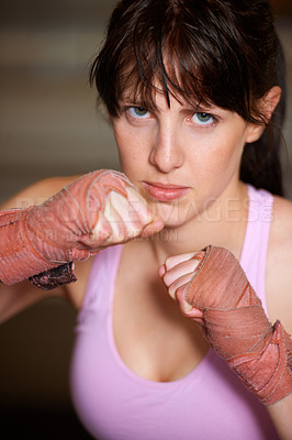 Buy stock photo Boxing, hands and serious portrait of woman with fitness, power and fearless training challenge in gym. Strong body, muscle and face of boxer, athlete or girl with fist up for confidence in fight.