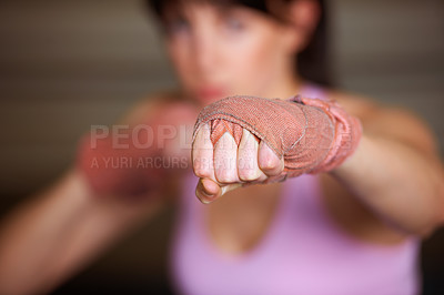 Buy stock photo Boxing, punch and hand of woman with fitness, power and fearless training challenge in gym. Strong body, muscle and blurred boxer, athlete or girl with fist up for confidence in competition fight.
