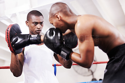 Buy stock photo Black man, boxer and personal trainer in ring fight at gym for workout, exercise or self defense training together. African male person with boxing or sparing partner preparing for sports competition
