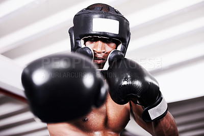 Buy stock photo An african american boxer wearing protective gear standing in the ring