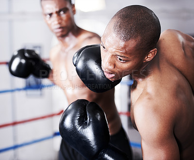 Buy stock photo Boxing, black man and sparring partner with punch in ring together with fitness, power strike and training challenge. Strong body, hit and boxer in gloves, fearless and confident in competition fight