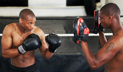 Buy stock photo Boxing, coaching and black man with personal trainer for fitness, power or training challenge. Strong body, sparring partner and boxer in gym with fist up, workout and confidence in competition fight