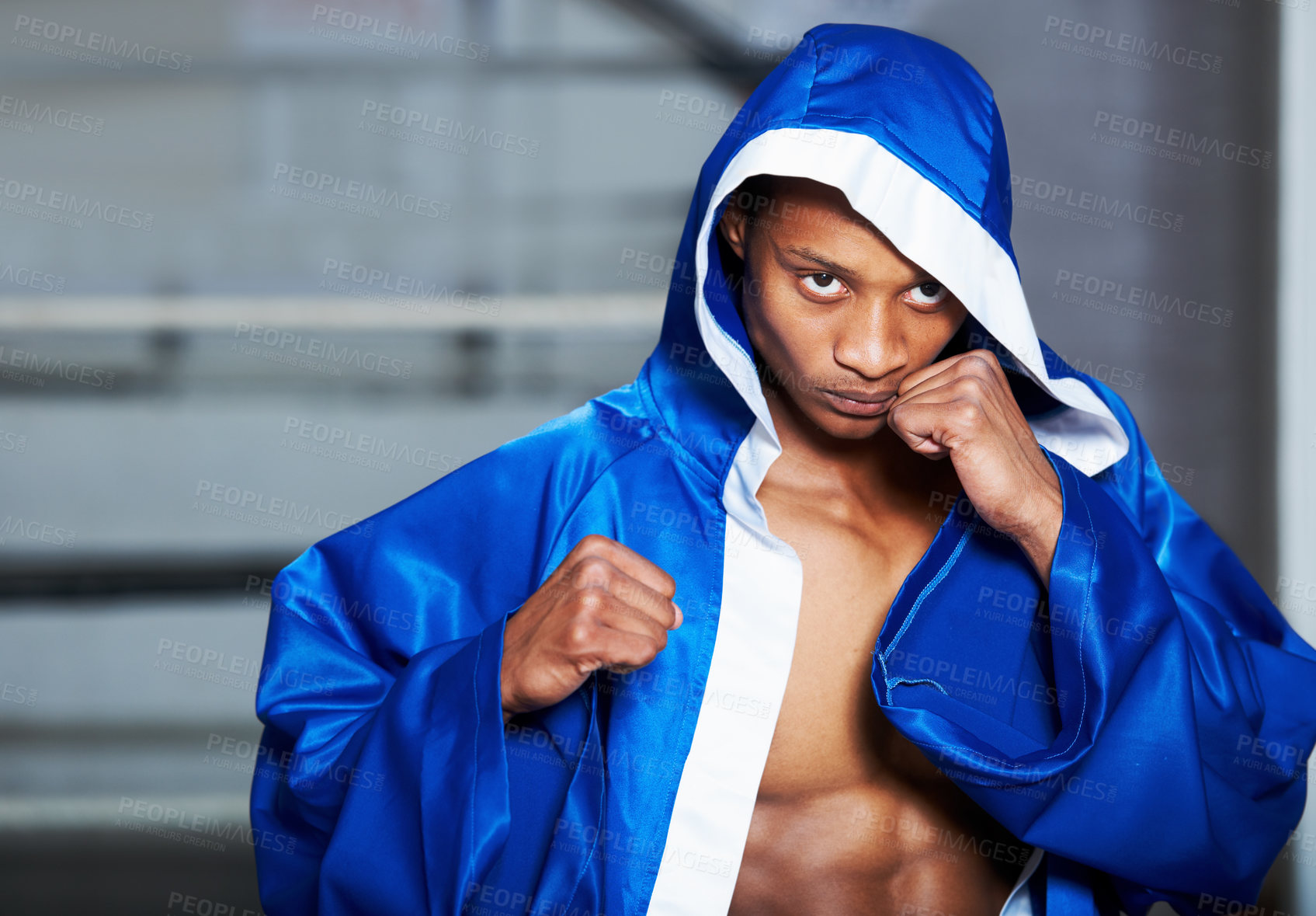 Buy stock photo Black man, boxer and champion in robe at gym getting ready for fight, challenge or sports competition. Serious African male person or boxing fighter with fists in preparation for MMA match or game
