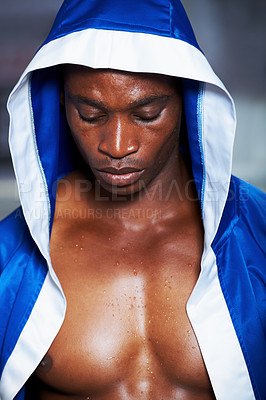 Buy stock photo Black man, boxing champion and robe getting ready for fight, challenge or sports competition at gym. Face of serious African male person, fighter or professional boxer in MMA, match or game start