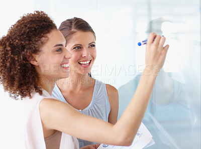 Buy stock photo Happy business woman, coaching and writing for planning, presentation or schedule at the office. Female coach or mentor with smile for project plan, tasks or training staff on whiteboard at workplace