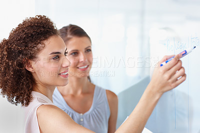 Buy stock photo Happy business people, whiteboard and writing for planning, presentation or schedule at the office. Woman, coach or mentor smiling for project plan, tasks or training staff and coaching at workplace