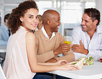 Buy stock photo A pretty young woman enjoying lunch with her colleagues