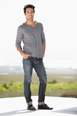 Buy stock photo Full length portrait of a handsome young man standing outside with his hands in his pockets