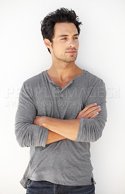 Buy stock photo Crossed arms, fashion and young man by a white wall with casual, cool and trendy outfit. Serious, confidence and handsome male model from Canada standing and posing with edgy style for aesthetic.