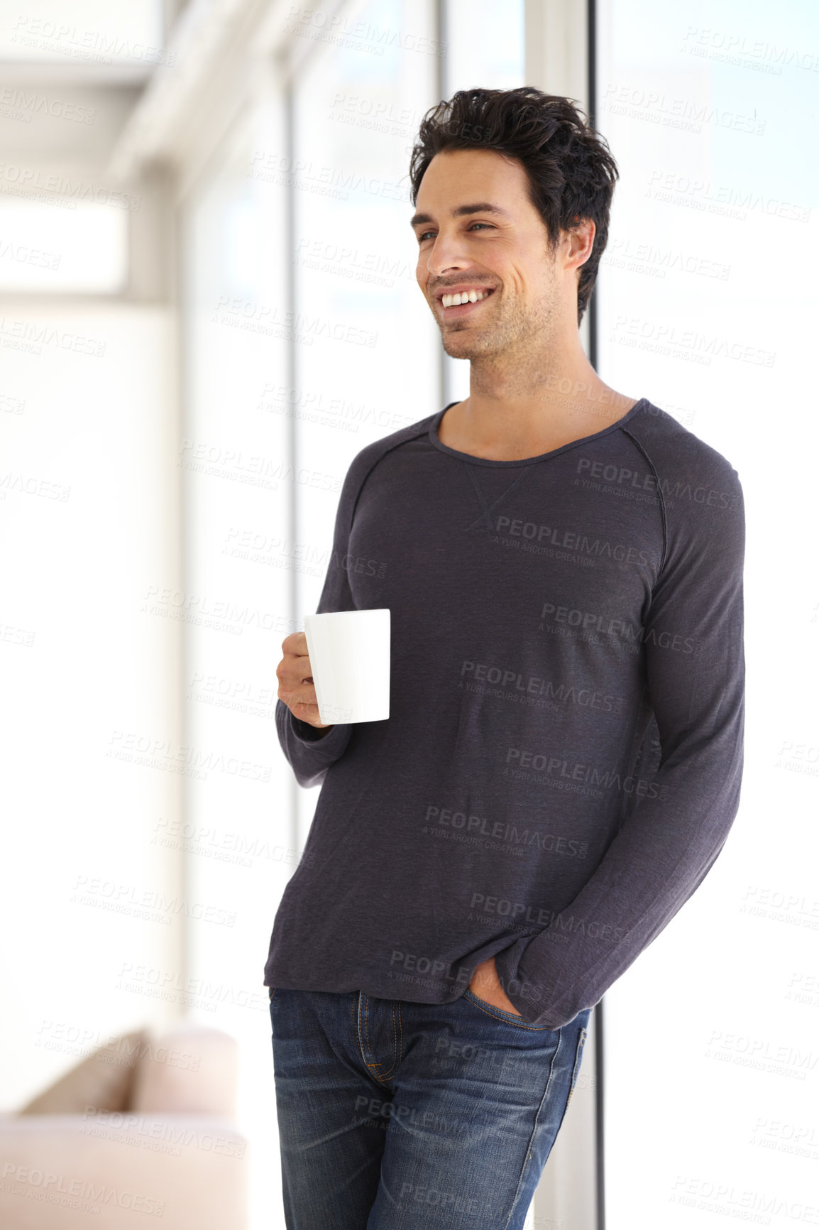 Buy stock photo Happy, smile and man with a cup of coffee standing by the window in a vacation house. Calm, relax and attractive male person drinking a latte in a mug in the living room while thinking or in a dream.