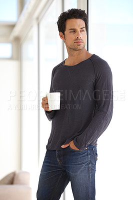 Buy stock photo Handsome, young and man with a cup of coffee standing by the window in a vacation house. Calm, relax and attractive male person drinking a capuccino in the living room while thinking or daydreaming.
