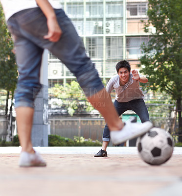 Buy stock photo Rear-view of a player ready to kick a soccer ball while the goalie stands ready